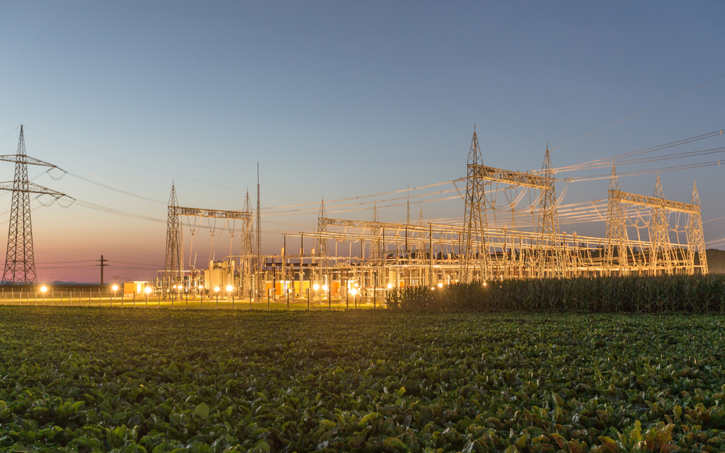 Floodlit transmission substation at dusk — substation PAC engineering & integration delivers turnkey protection, automation and control (substation brochure photography)